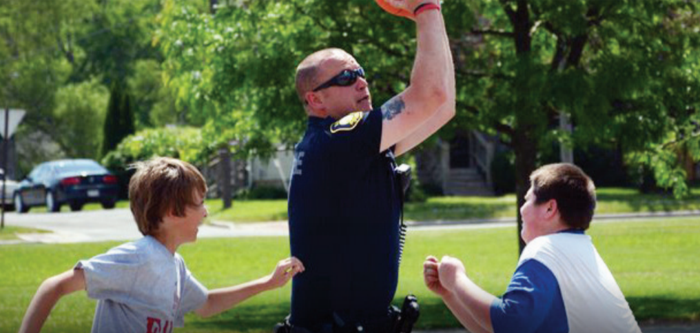 Police officer playing basketball